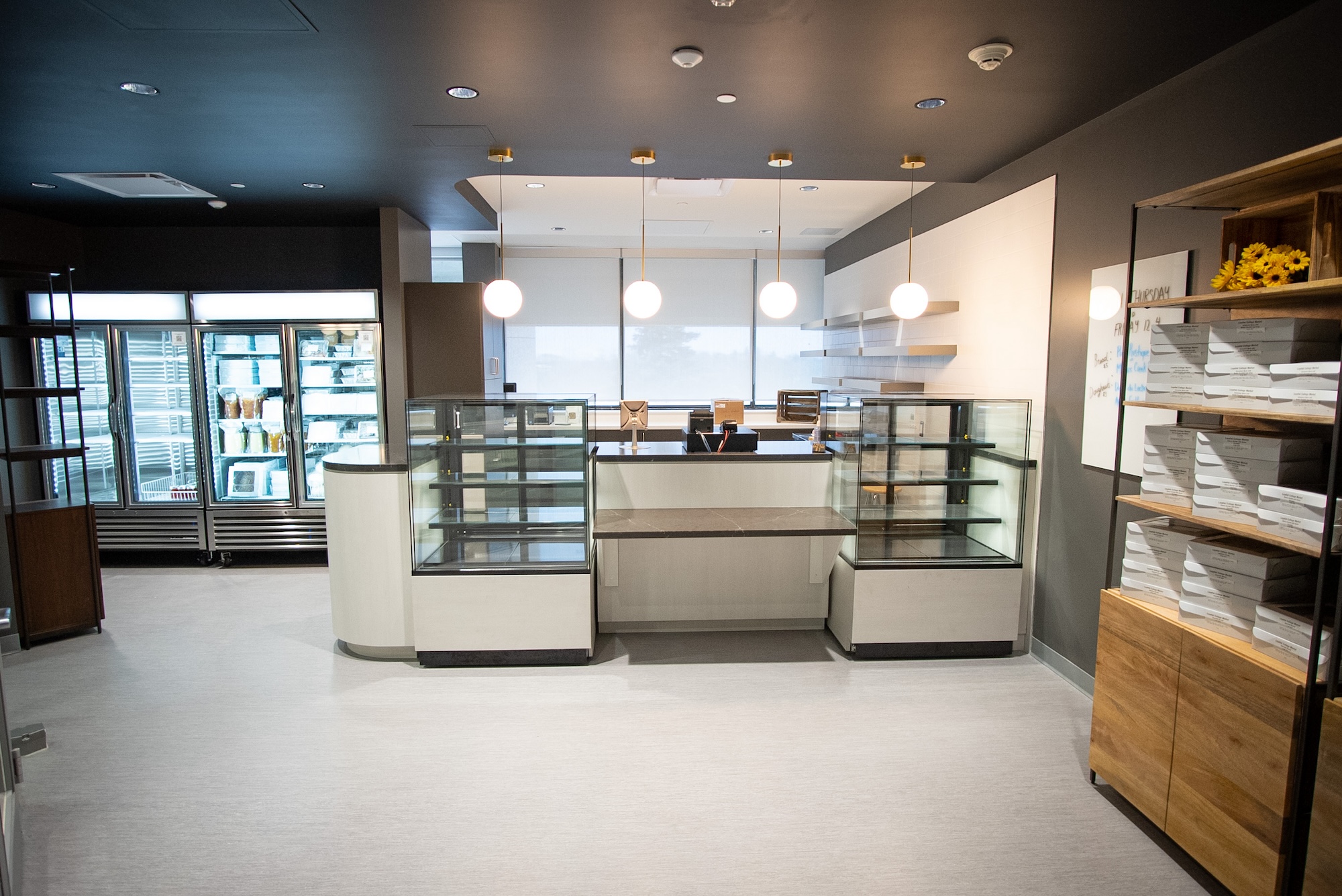 The Market is shown, with empty shelves, an order desk, and fridges beside.