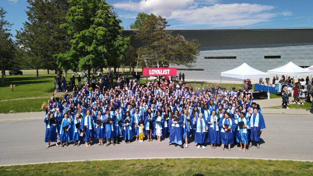 A drone shot of a group of Loyalist College graduates wearing blue gowns at their Convocation ceremony.