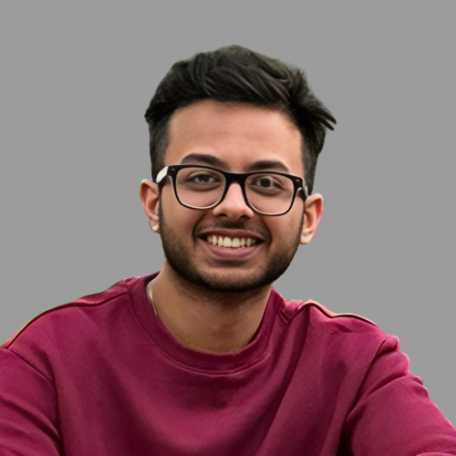 A headshot of Madhav Sharma in front of a dark grey background.