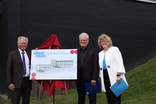 Acting Loyalist College President Mark Kirkpatrick, Mayor of Port Hope Bob Sanderson, and Former Loyalist College President Dr. Ann Marie Vaughan posing with a rendering for the new Port Hope campus.