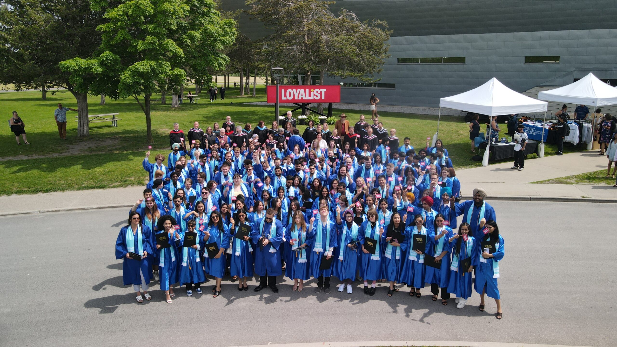 Drone shot image of Loyalist's Convocation graduates out front of the Kente Building.