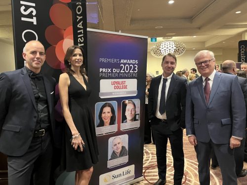 Four people posing with a sign at the 2023 Premier's Awards. The people included in the photo are Mark Kirkpatrick, Janak Alford, Lisa Kirbie and Mike Shoreman.