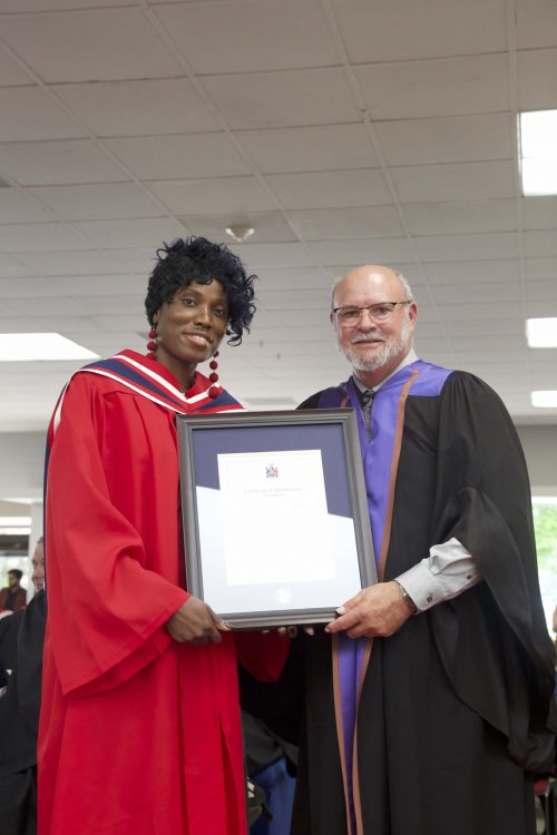 Jacinta Obasohan, a Loyalist student, receiving recognition for involvement with the Board of Governors. She's being presented a certificate by Professor Culhane of the Limerick Institute of Technology.