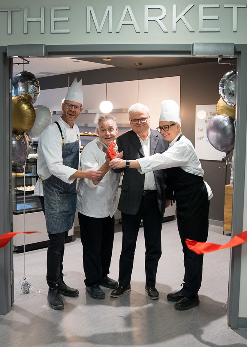 President and CEO Mark Kirkpatrick and three culinary professors cutting the ribbon on the newly opened Market.