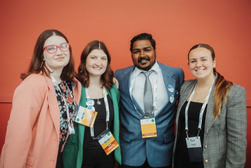 Loyalist students and Enactus members Maya Phaneuf, Arvind Sharma and Madison Bernard posing with Olivia Millard, Student Experience and Engagement Manager.