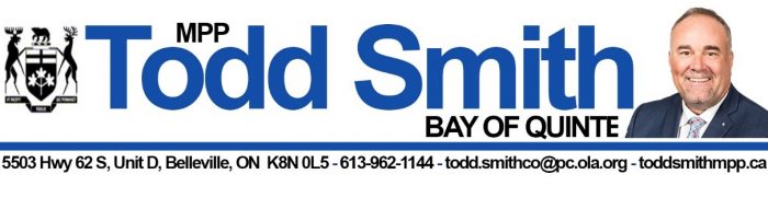 Banner featuring Todd Smith, MPP for Bay of Quinte. The banner includes Todd Smith's name in large blue text with a small photo of him in a suit and tie on the right. On the left is a coat of arms. Below, there is contact information: 5503 Hwy 62 S, Unit D, Belleville, ON K8N 0L5, phone number 613-962-1144, email todd.smithco@pc.ola.org, and website toddsmithmpp.ca.