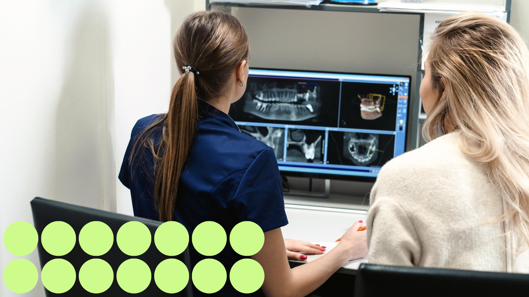 Students reviewing dental X-rays and imaging. There are 14 small green circles on the lower left hand side of the image.