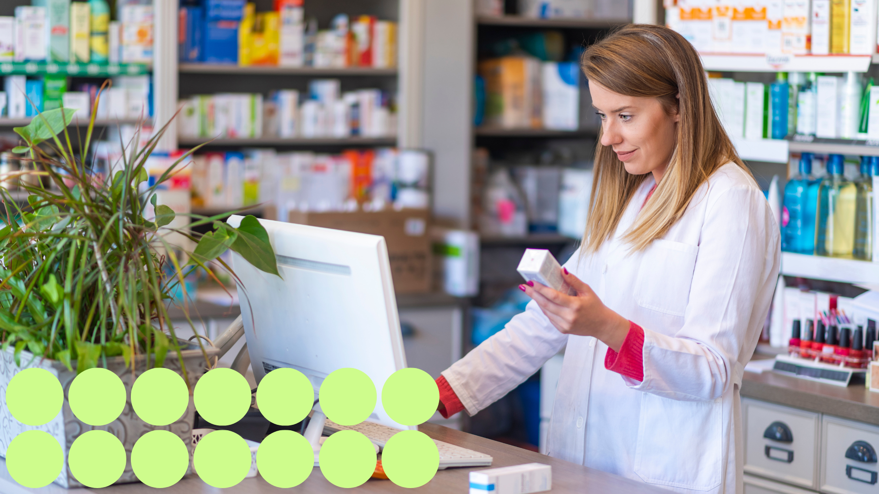 Pharmacy worker checking medication at a computer.