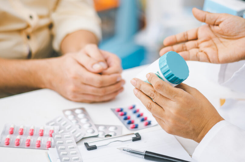 Pharmacist discussing prescription medication with a patient.