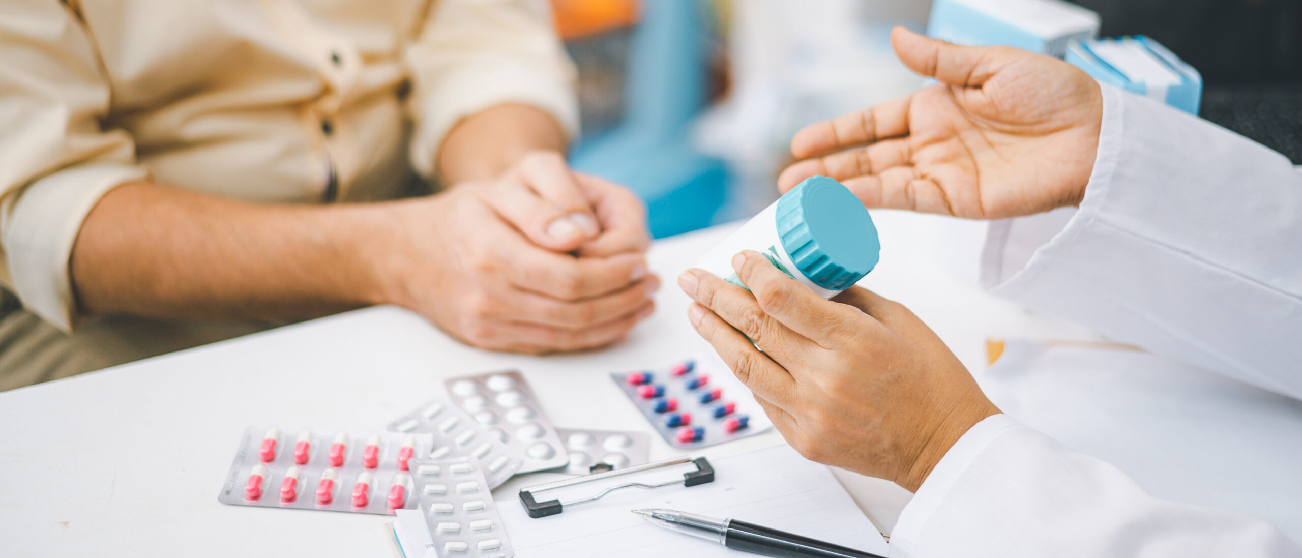 Pharmacist discussing prescription medication with a patient.