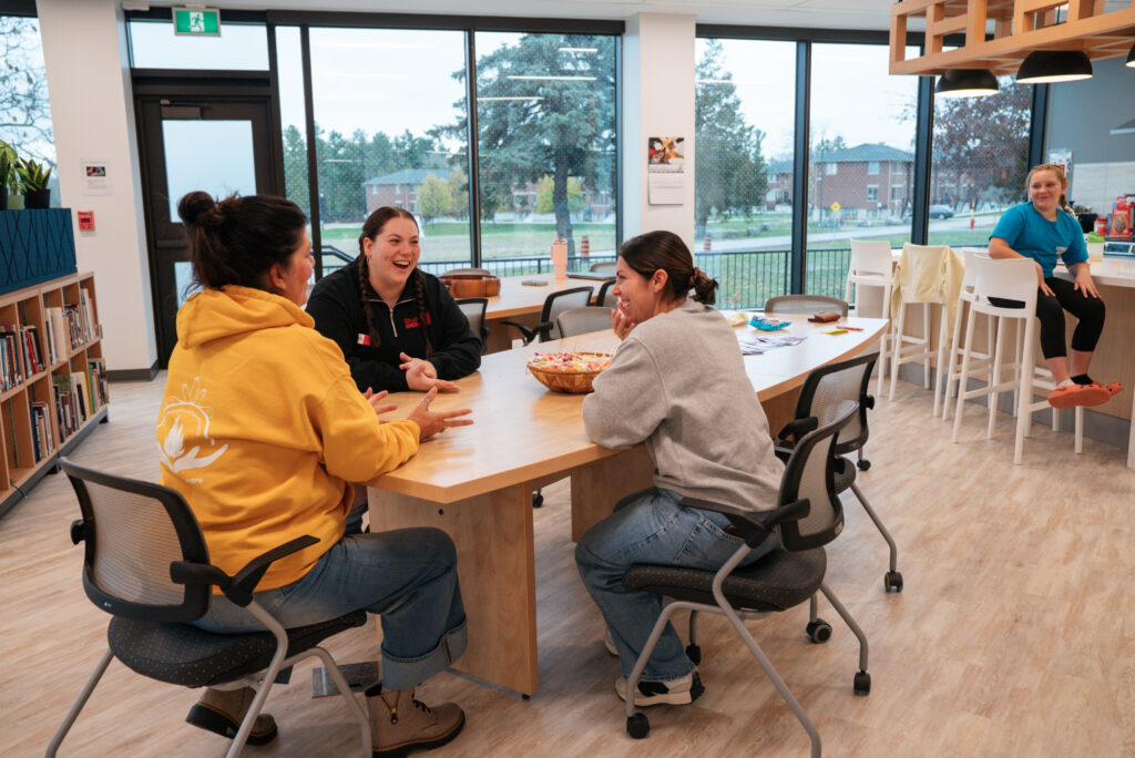 Loyalist College Indigenous Resource Centre staff and students gather at the family table in the new Tsi Titewaya'taró:roks Indigenous Centre.