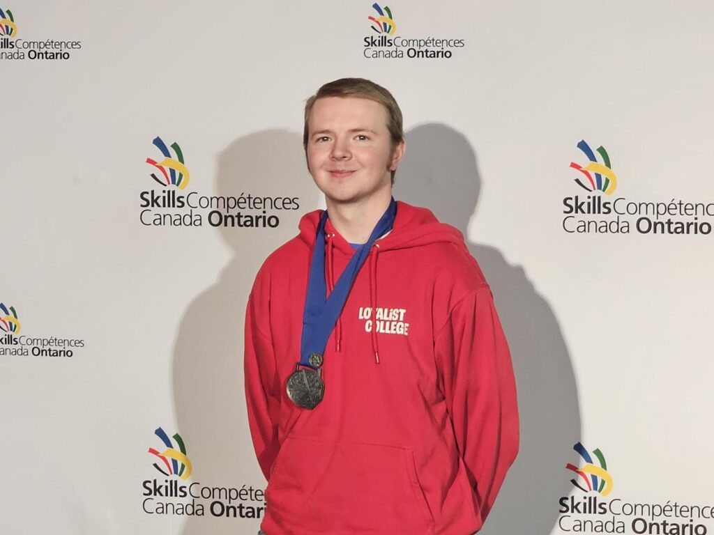 Loyalist College student Britton Creasy smiles with his silver medal at the 2026 Skills Ontario Competition