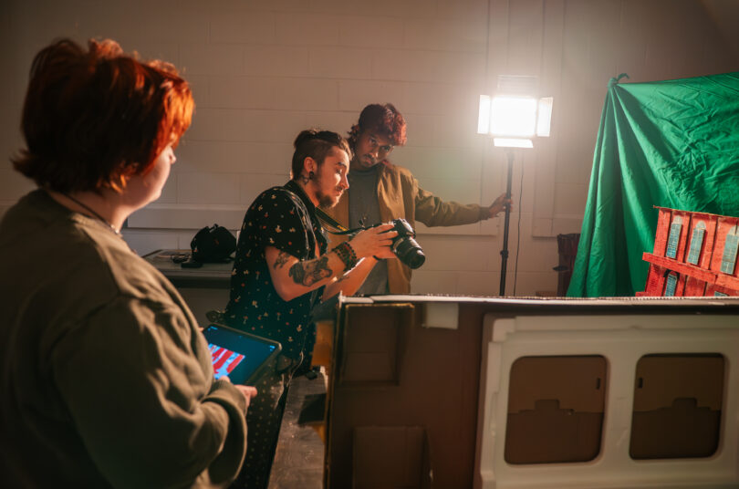 The Art and Design Foundations program student takes photograph in studio.
