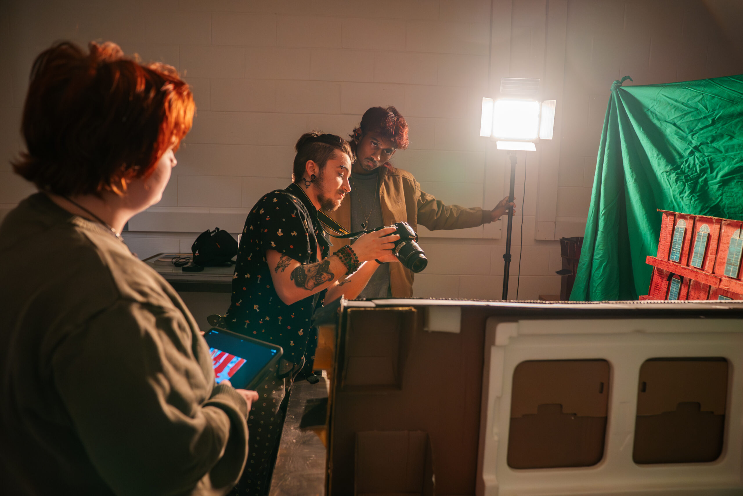 The Art and Design Foundations program student takes photograph in studio.
