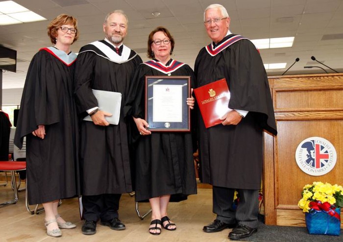 During the second of four Convocation Ceremonies held at Loyalist in Belleville, Ontario on June 4, 2015, guest speaker Ms. Sheila Watt-Cloutier (centre) receives an Honorary Diploma from Chair of the Loyalist Board of Governors Brian Smith (right). Also pictured are Loyalist College President & CEO Maureen Piercy (left) and Senior Vice-President, Academic and Student Success John McMahon (centre left). 