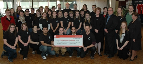 Caption: President Piercy and members of the Loyalist community, including Public Relations students and Student Government, present a cheque to David Allen, Campaign Chair for the United Way of Quinte.
