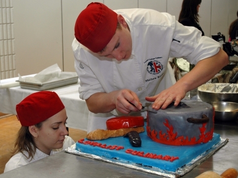 Loyalist second year students decorate cake.