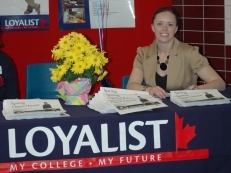 Chantel Dilts from Loyalist Recruitment welcomes guests to the Open House.