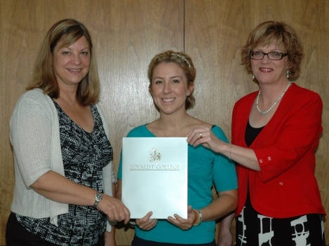 Emily Skinkle (centre) was awarded the scholarship by Loyalist President Maureen Piercy (right) and Karen Brooks Cathcart, Dean, School of Health and Human Studies (left).