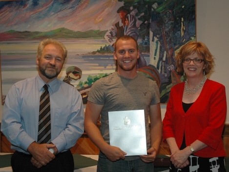 Vice-President Academic John McMahon (left) and Loyalist College President Maureen Piercy (right) present Darren Morgan with his Entrance Scholarship Award at the presentation ceremony September 19th.