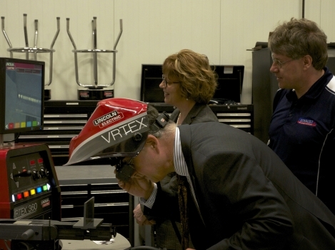 Welding Professor John Grieve (right) shows Loyalist President Maureen Piercy (centre) and Jody DiRocco, Director of Education and Secretary to the Board, Algonquin and Lakeshore Catholic District School Board (left), how to use the College’s Virtual Welder.  
