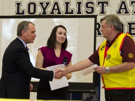 Rotary Club of Quinte Sunrise President Steve Lichty (left) and Loyalist College Rotaract President Chanelle Schryer present a letter to Rotarian Bob Wallace acknowledging a $300 donation made in his name to the “End Polio Now” campaign. 