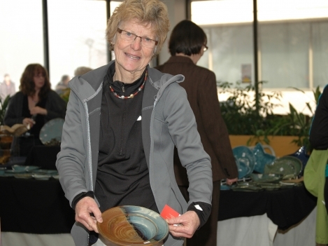 Helga Eckstein holds one of the bowls she made for the sale.