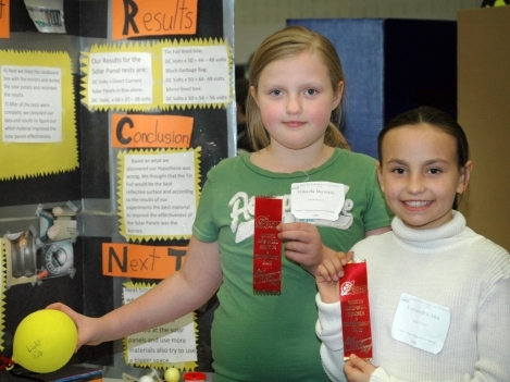 Mikaela Ihamaki (left) and Cassandra Aho from St. Mary's School in Trenton proudly display their red ribbons.